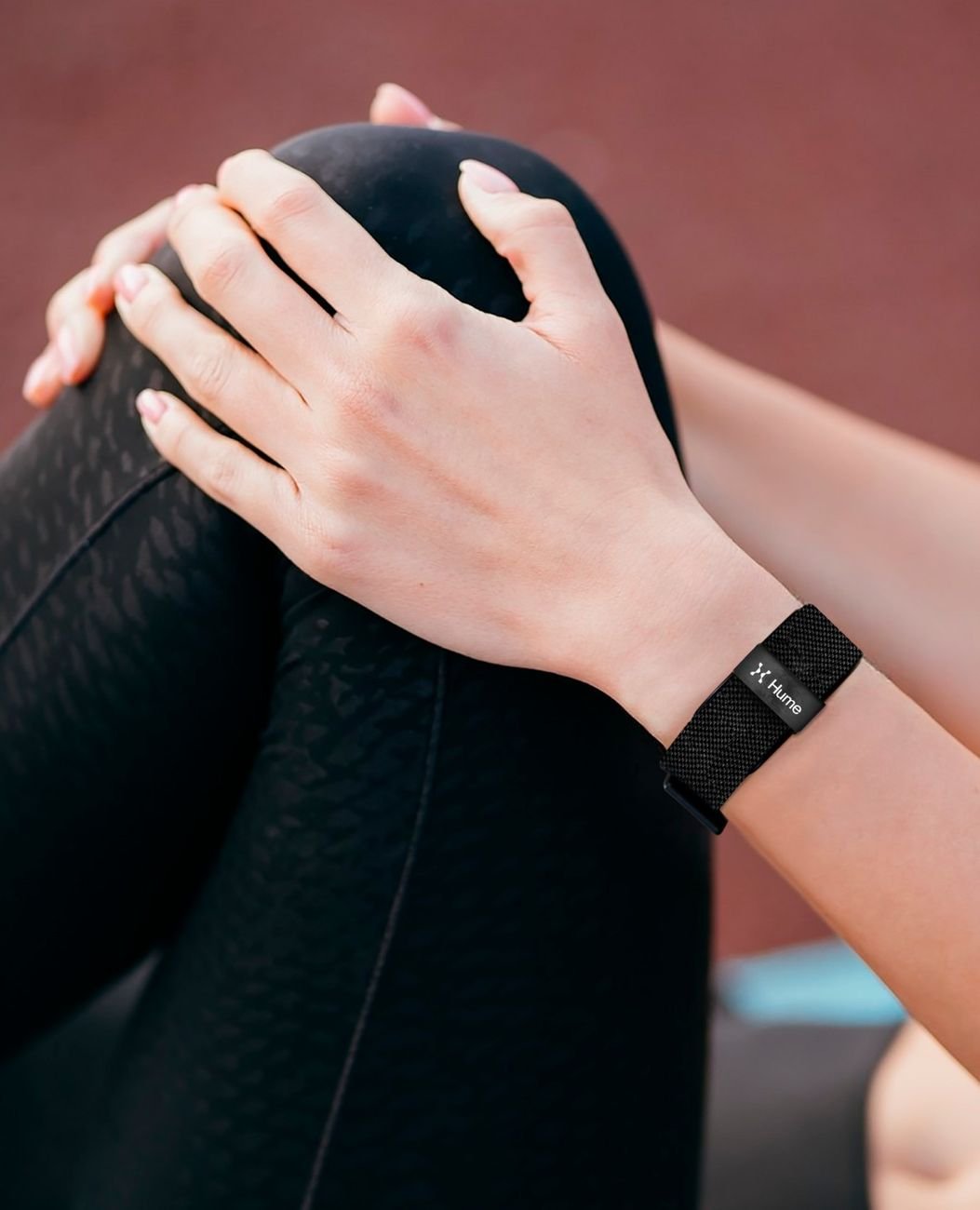 Close-up of a wrist wearing the Hume Band during a stretching session